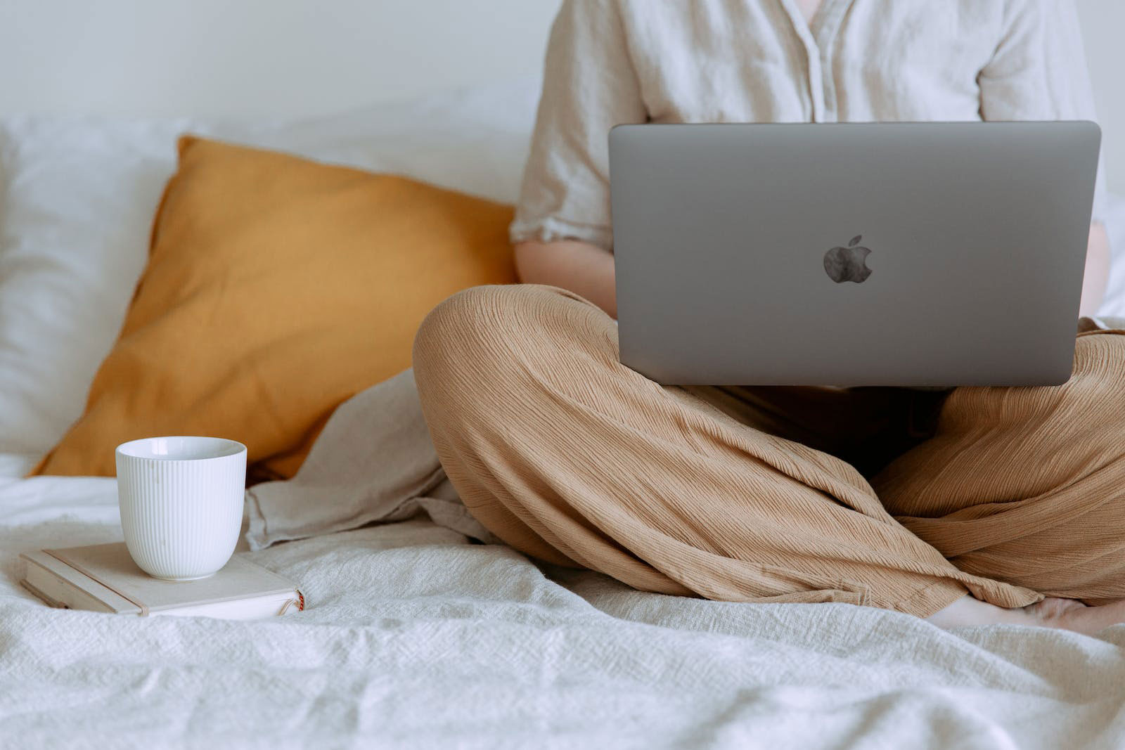 service women on computer in bed