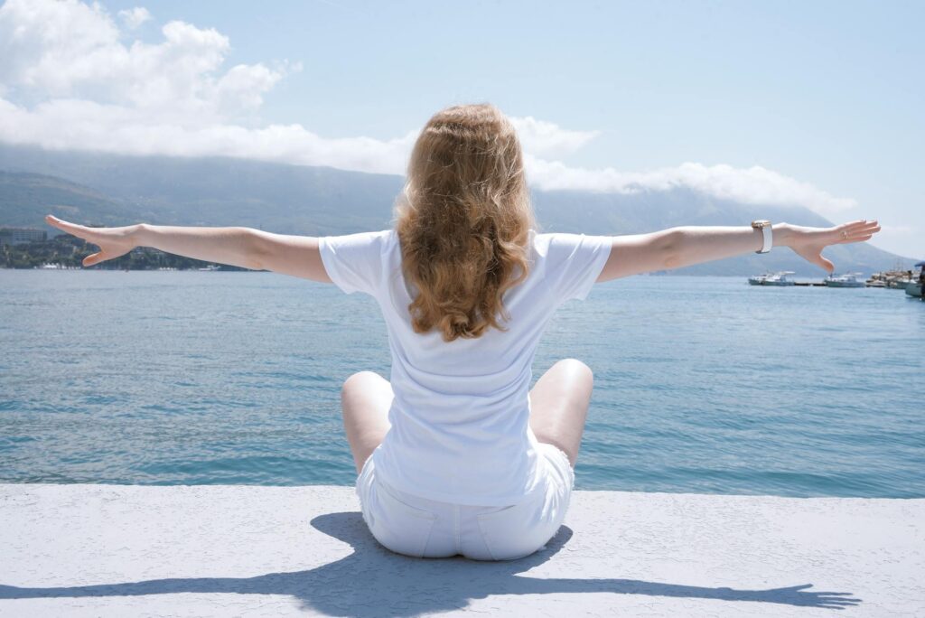 Neuro Emotional Technique on Chronic Low Back Pain.:mphoto of woman sitting near body of water